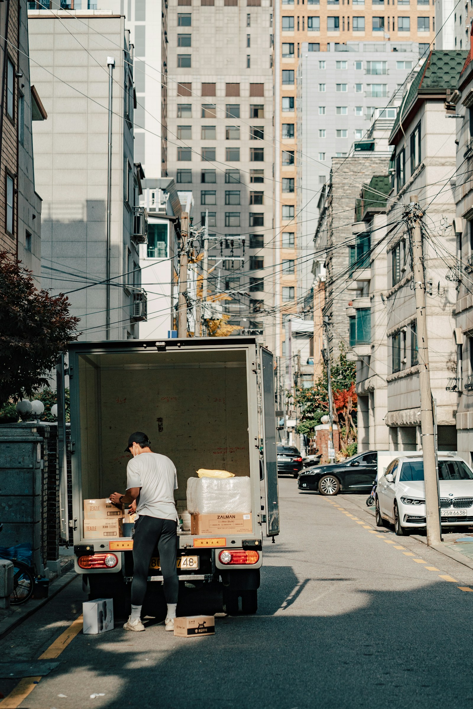 Worker unloading boxes from the back of a moving truck
